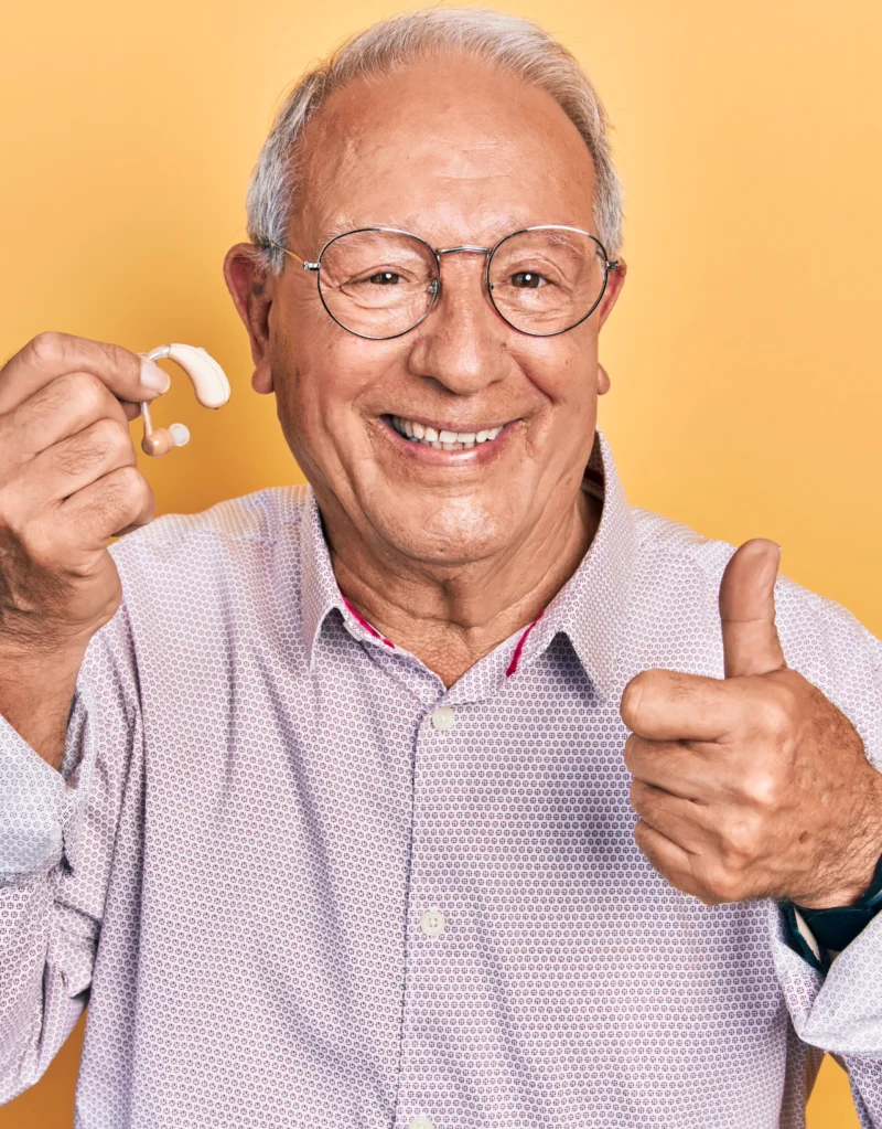 Smiling older man giving a thumbs up after his hearing appointment